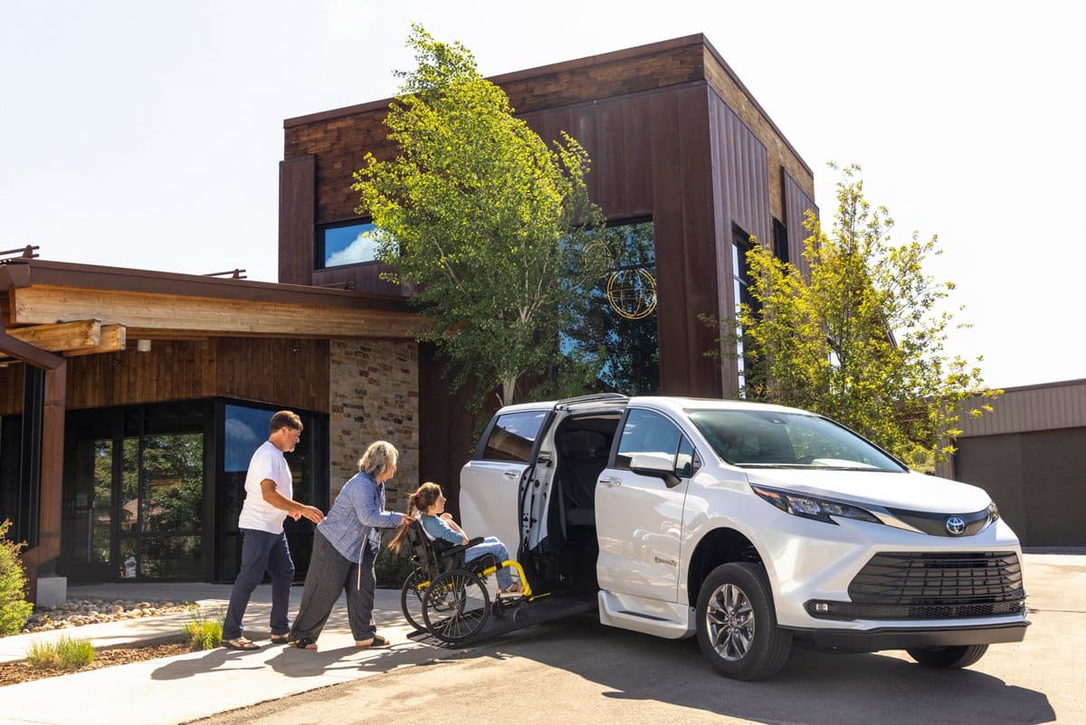 BraunAbility wheelchair accessible Toyota Sienna with side-entry ramp deployed outside a building